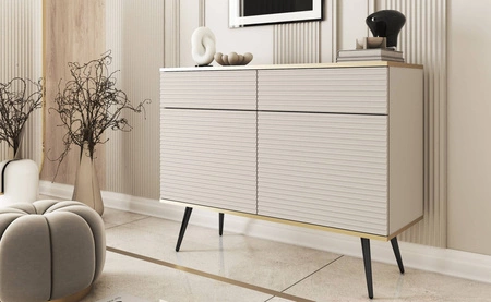 Luxusní 107 cm zásuvková komoda béžové barvy stylová komoda s drážkovanými čely korpus zakončený zlatým lemováním černé kovové nohy