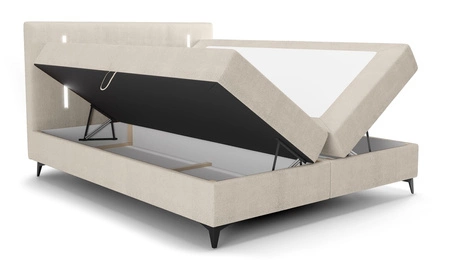 Kontinentální postel Norco 160x200 béžová Stylová postel s úložným prostorem na lůžkoviny Osvětlení v čele postele dodává posteli jedinečný nádech